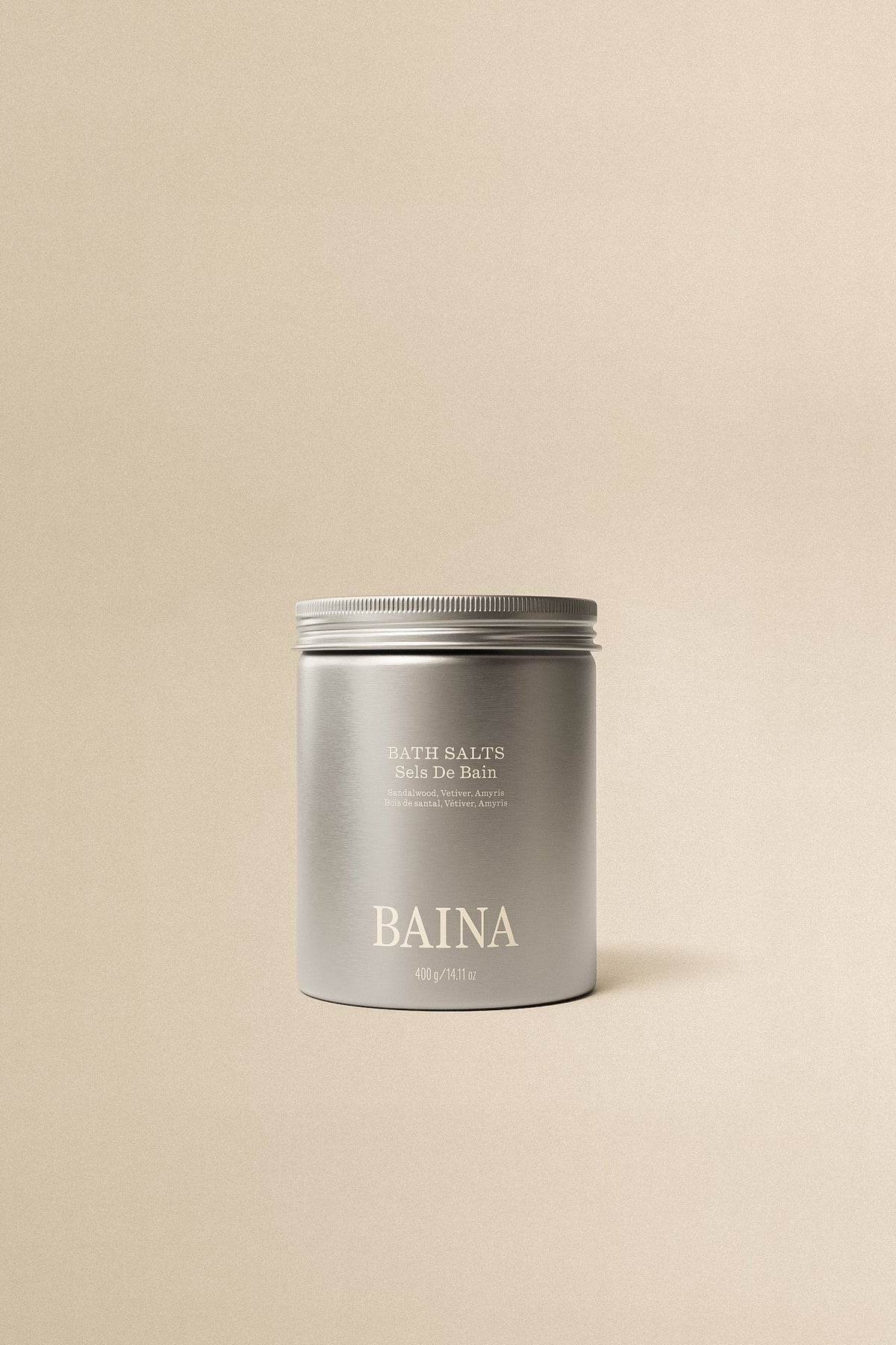 Baina bath salts in a clear glass jar with floral accents, perfect for relaxing baths and soothing skin care.