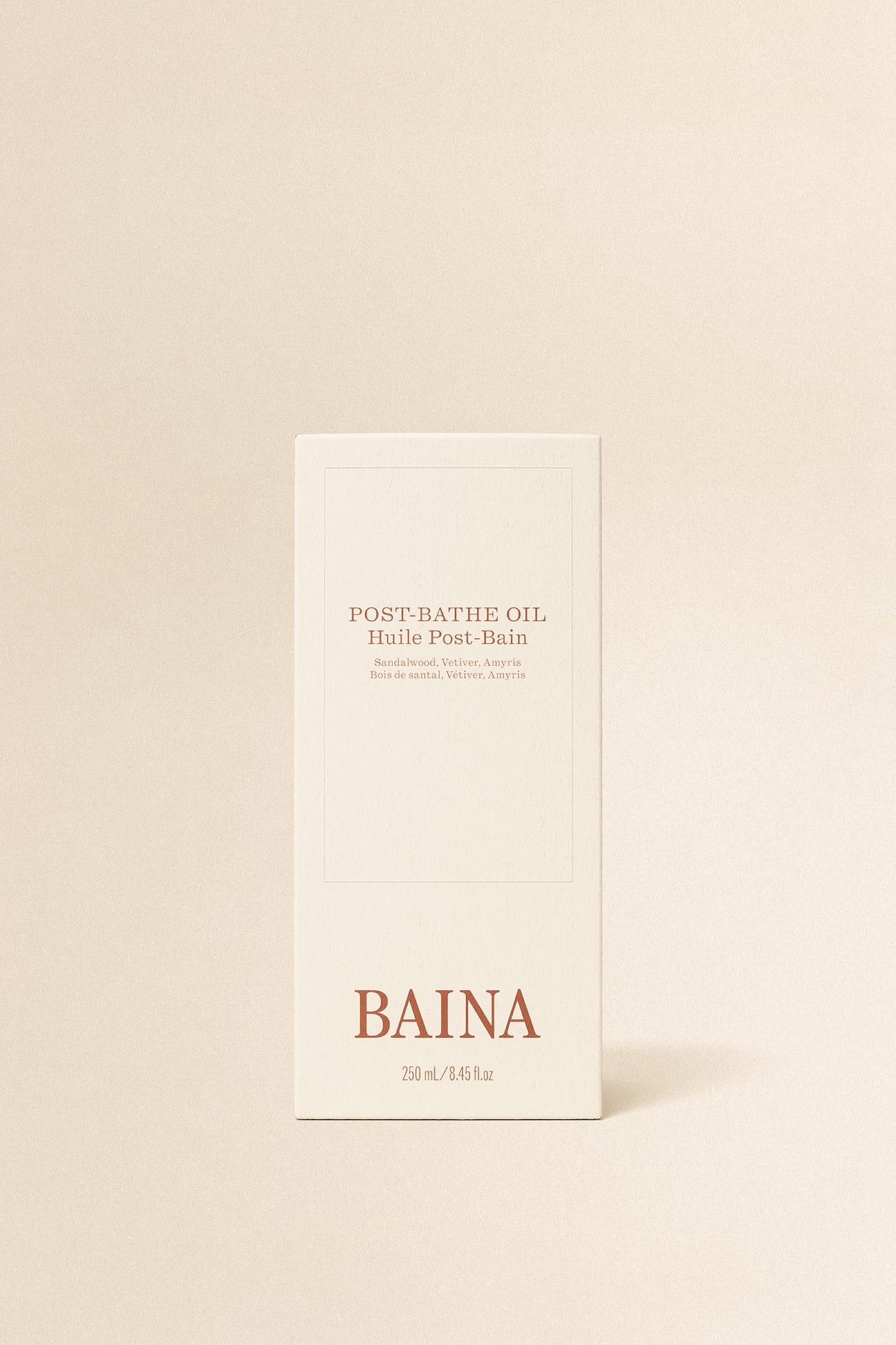 Baina post-bathe body oil bottle with golden cap and clear label, designed for nourishing skin after bathing.