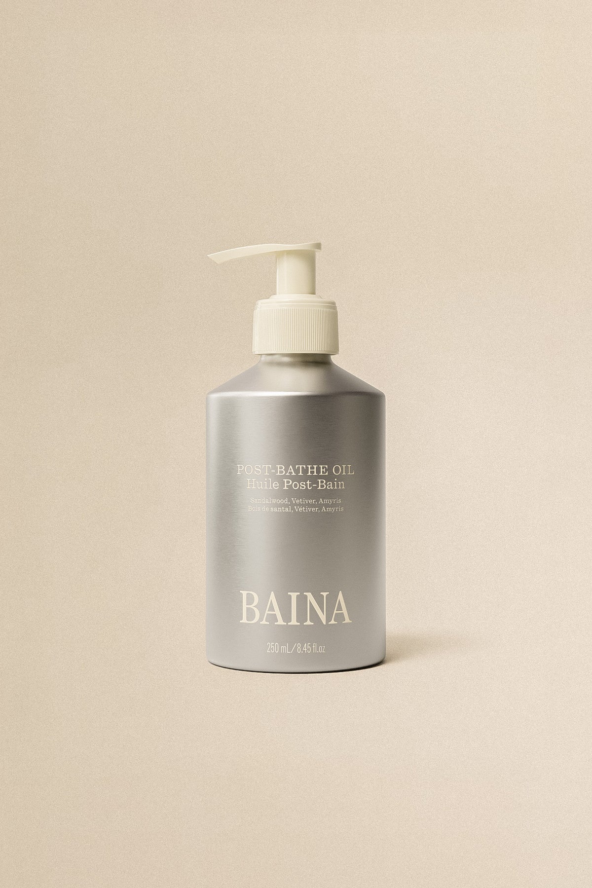 Baina post-bath body oil bottle with a clear liquid and natural ingredients, designed for moisturizing after bathing.