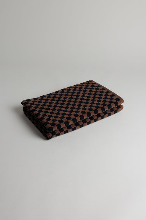 Baina Beppu bath mat in Tabac and Noir with soft, plush texture, ideal for bathroom decor and comfort.