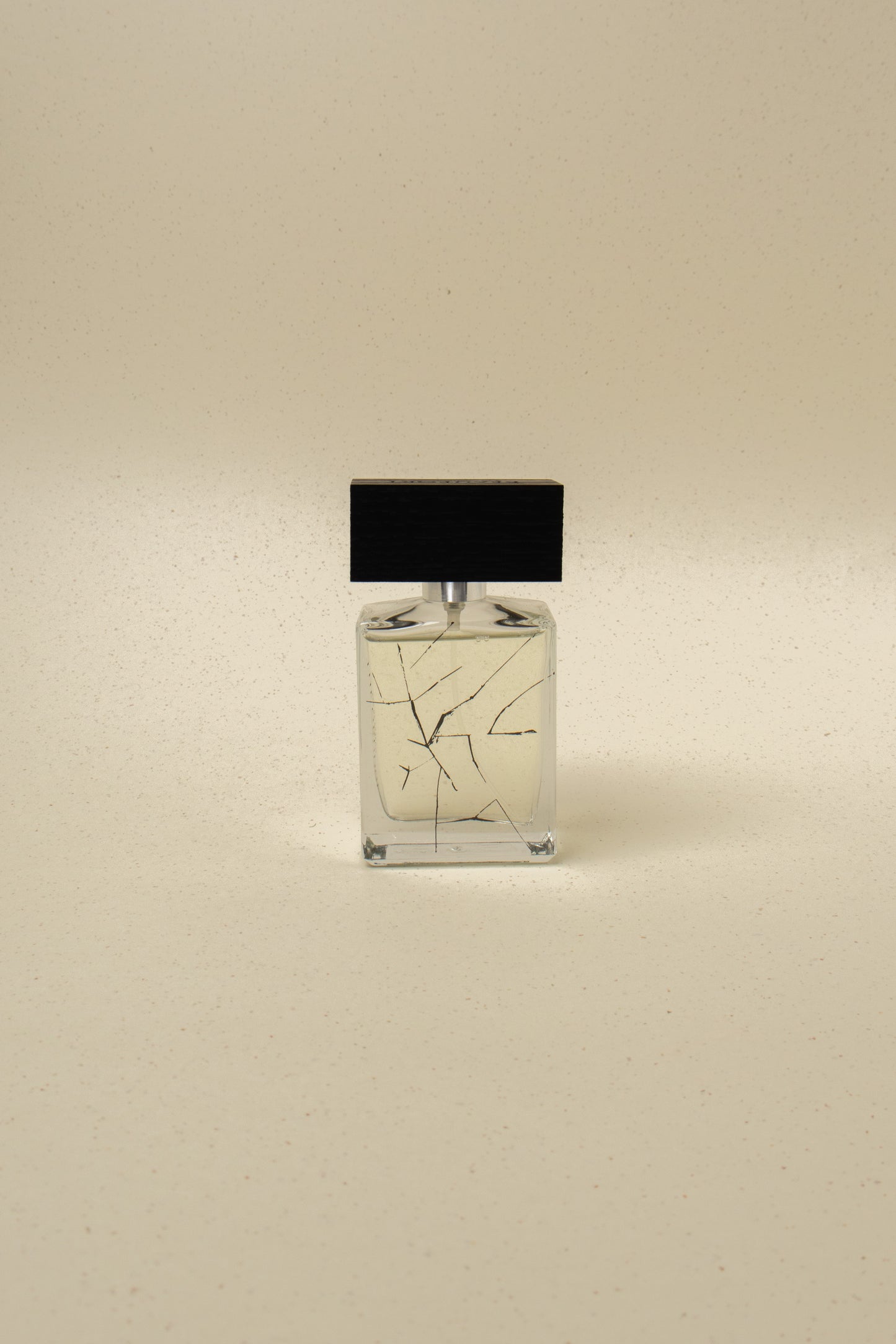 Minimalist perfume bottle with black wooden cap and abstract black line design on beige background