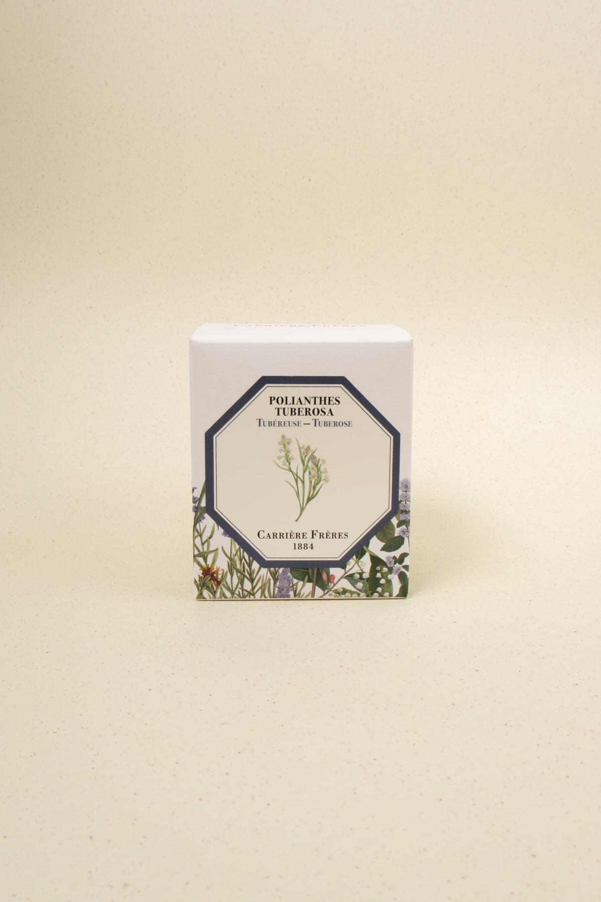 Carrière Frères Tuberose scented candle with a white ceramic jar and floral design, showcasing an elegant, fragrant candle for home decor.