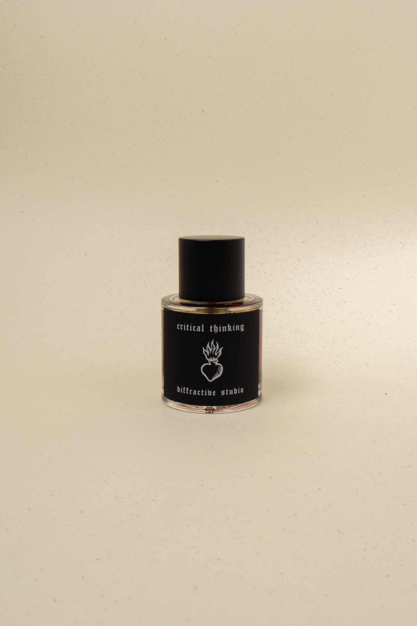 Diffraction Studio Critical Thinking perfume bottle with sleek, modern design and minimalist label on a neutral background.