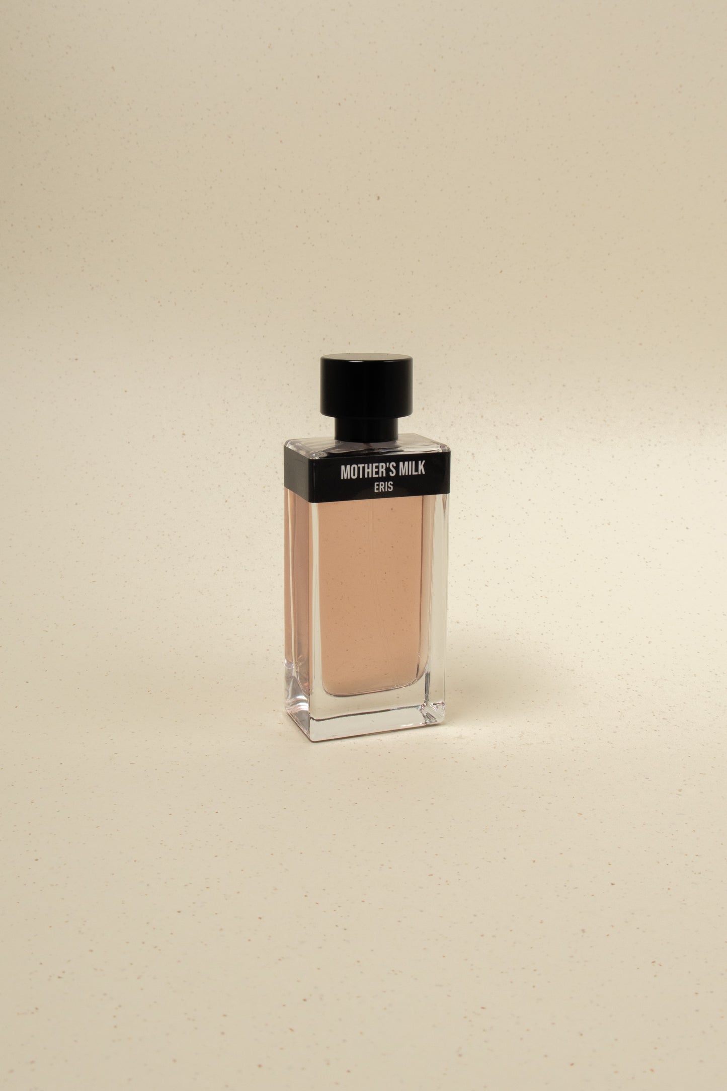 Eris Parfums Mother's Milk perfume bottle with elegant floral design and soft pink accents on a white background.