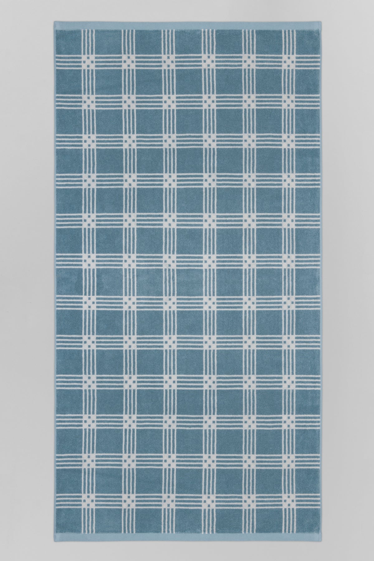 BAINA Frisa Pool Towel in Celeste and Chalk, flatlay showing soft, plush bath towel with vibrant blue and neutral tones.