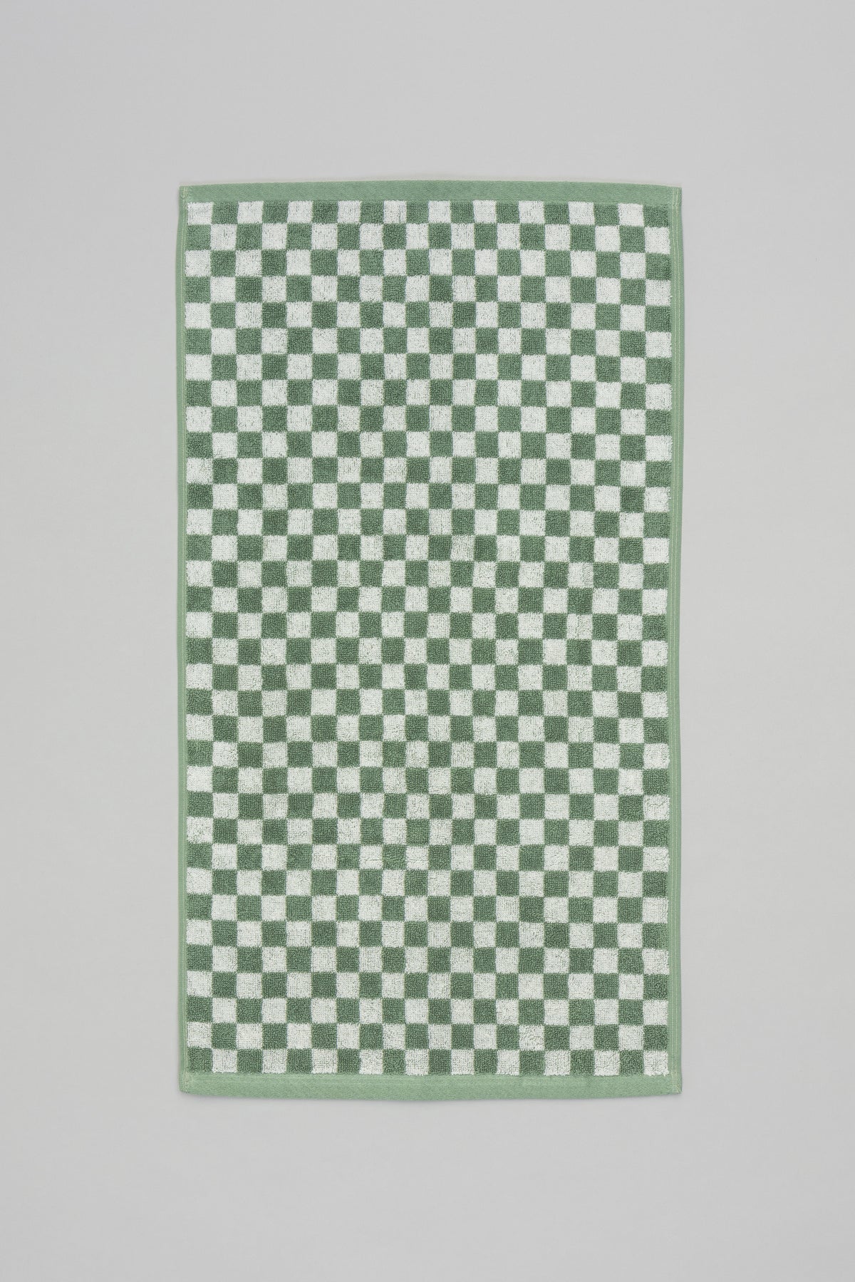 Baina Josephine hand towel in sage and chalk, flat lay showcasing soft fabric and elegant design for bathroom or kitchen use.