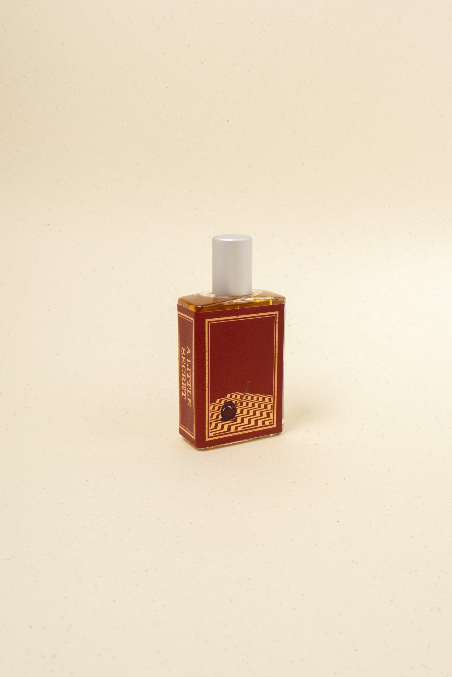 Imaginary Authors A Little Secret perfume bottle with a sleek design and elegant label, displayed on a neutral background.