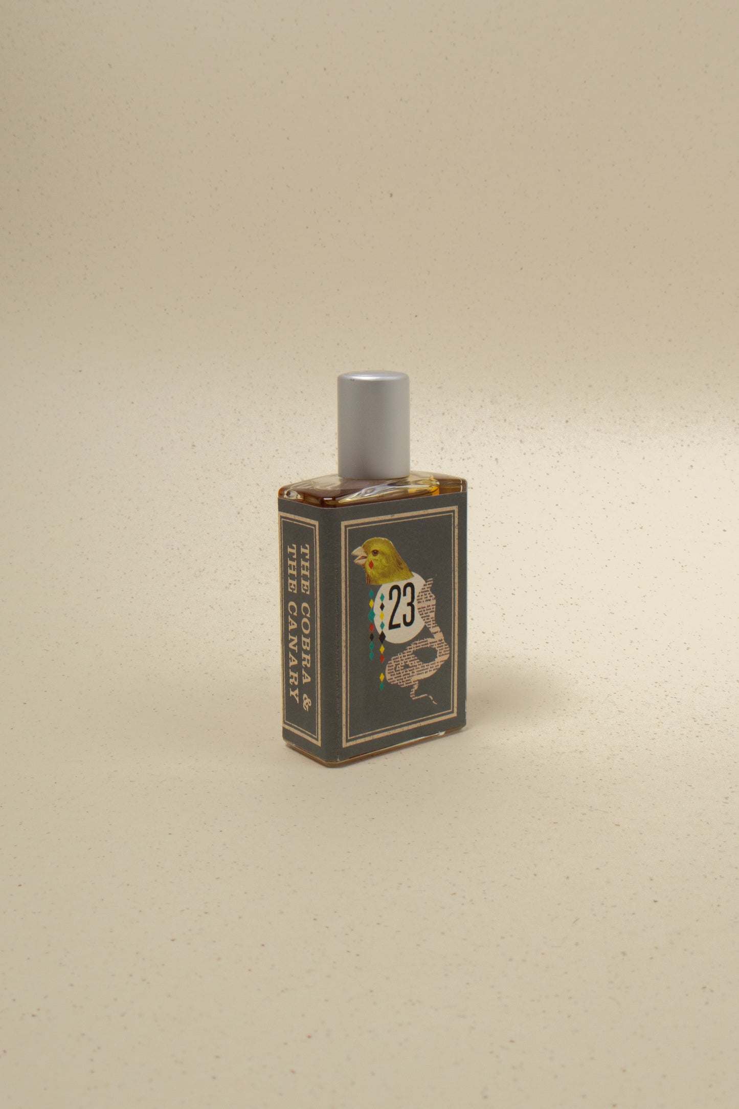 Imaginary Authors Cobra & The Canary perfume bottle with intricate design and gold accents on a neutral background.