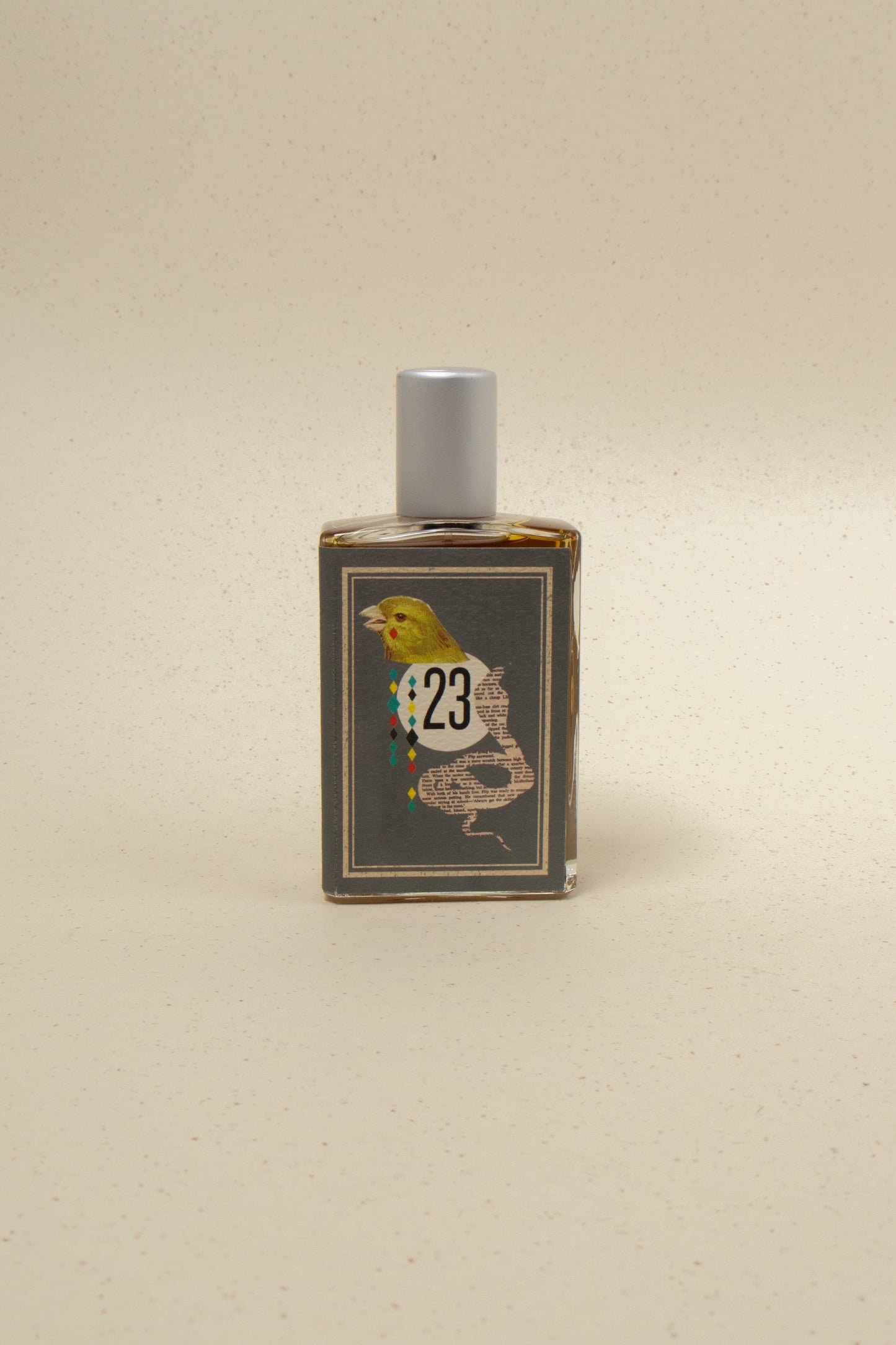 Bottle of The Cobra & The Canary perfume by Imaginary Authors featuring a sleek, modern glass design with a colorful label.
