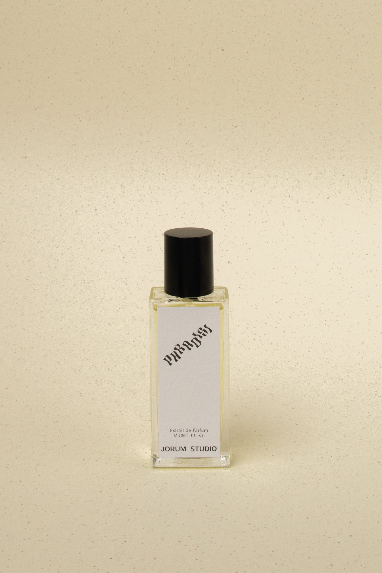 Jorum Studio Paradisi 30ml extrait de parfum bottle with black cap on speckled beige background