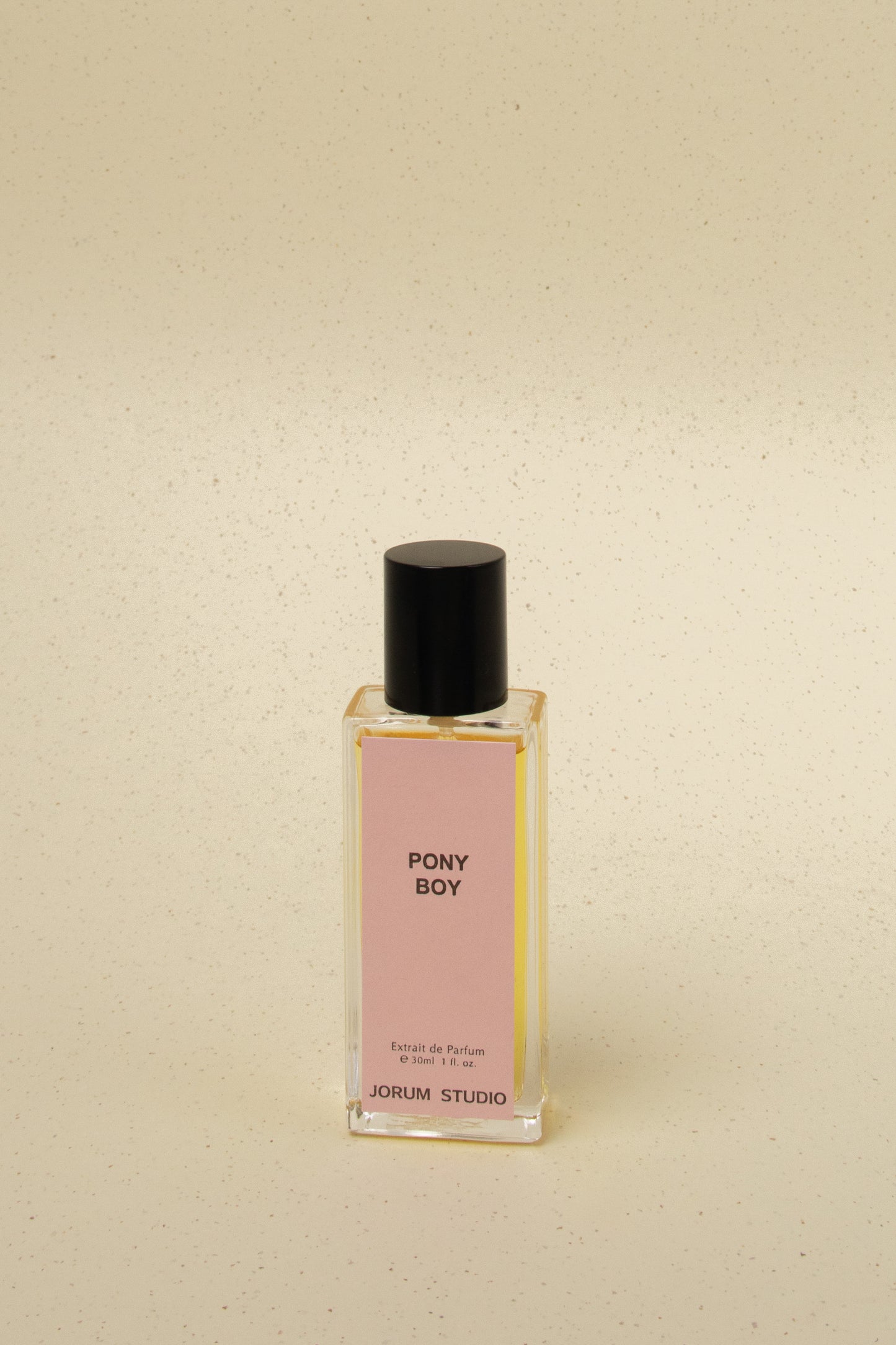 Jorum Studio Pony Boy Extrait de Parfum 30ml bottle with pink label and black cap on speckled beige background