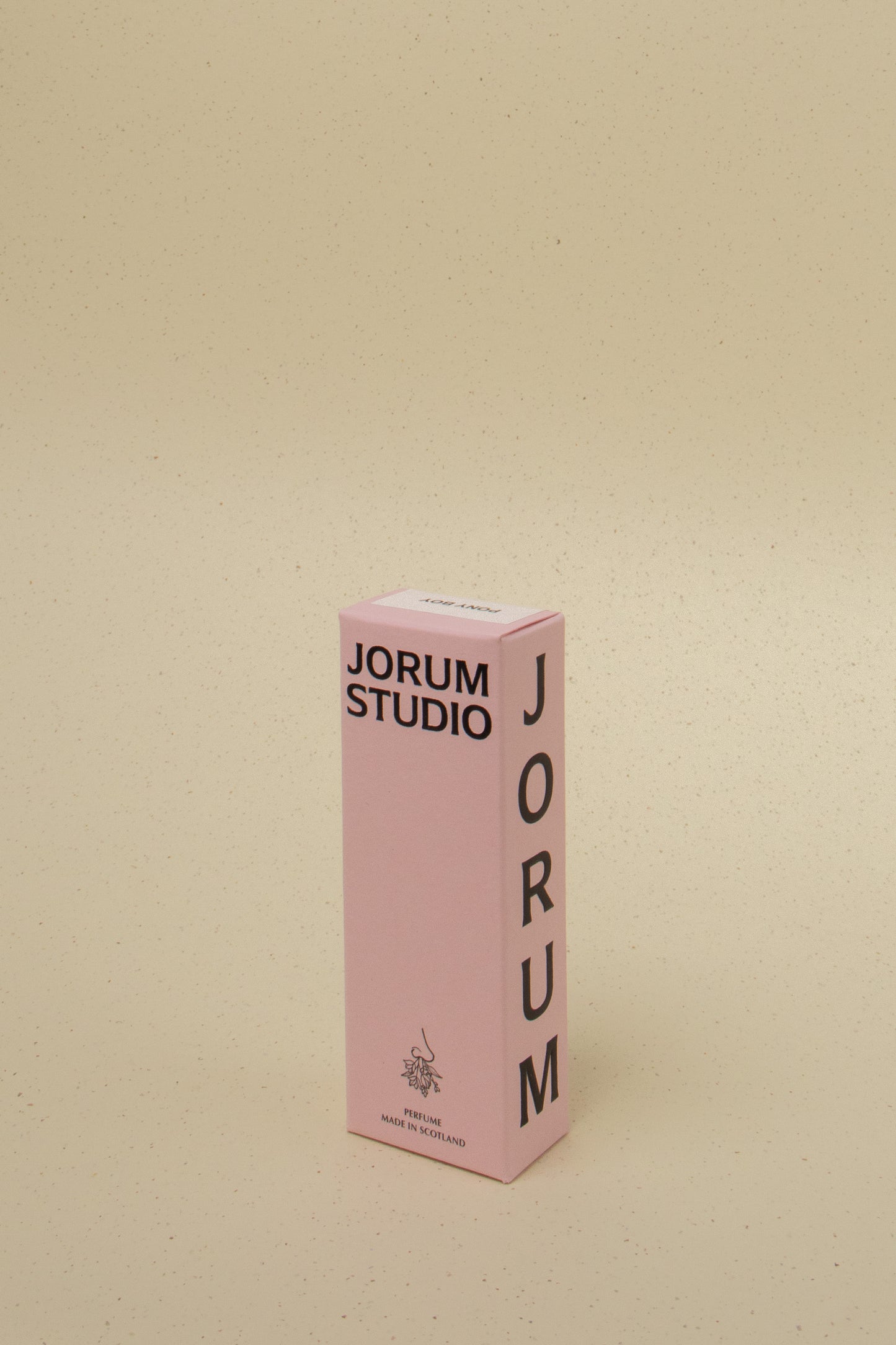 Pink Jorum Studio perfume box made in Scotland on beige speckled background