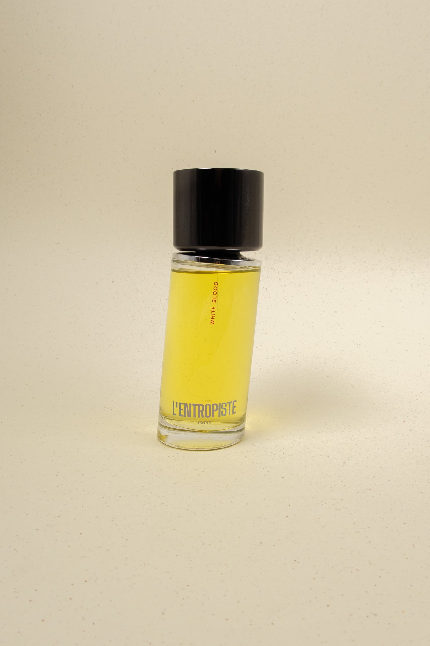 L'Entropiste White Blood perfume bottle with sleek white design and minimalist branding on a neutral background.