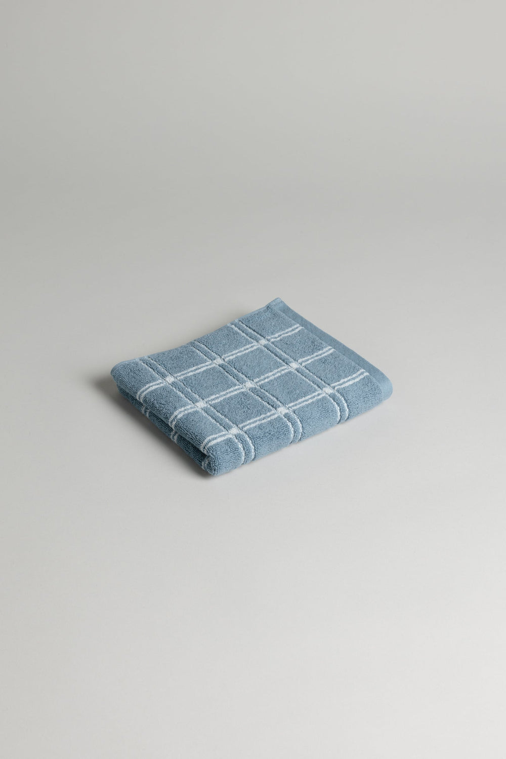 Baina Ness hand towel in Celeste and Chalk with soft, plush fabric and elegant design, suitable for bathroom or kitchen use.