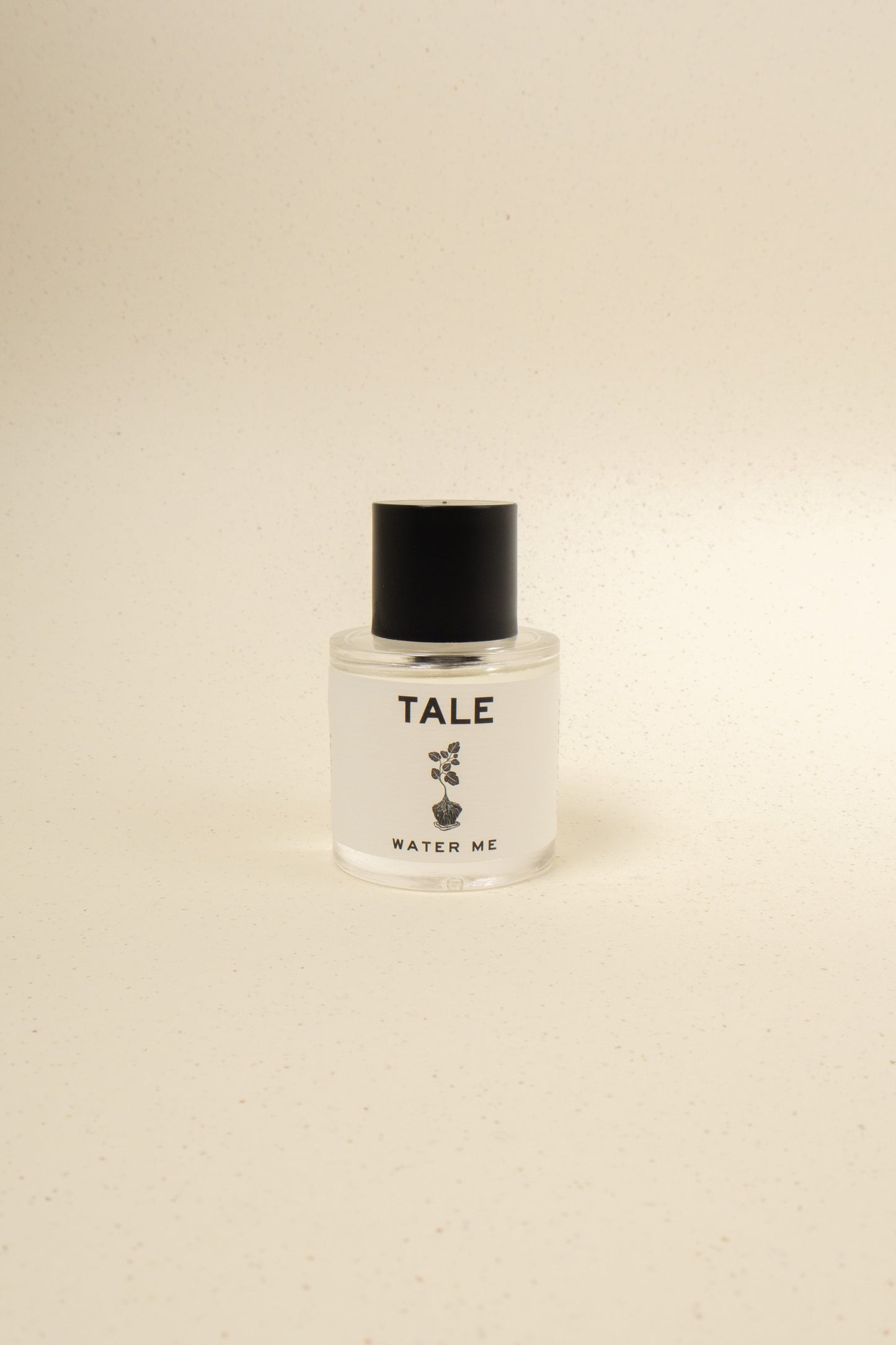 TALE Water Me perfume bottle with sleek design, featuring a clear glass container and minimalist label, on a white background.