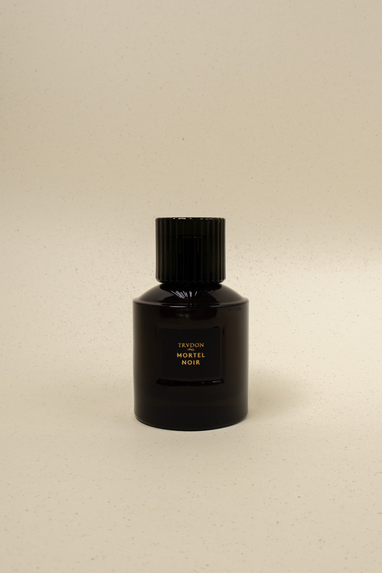Trudon Mortel Noir perfume bottle with sleek black design and elegant label, showcasing a luxurious fragrance.